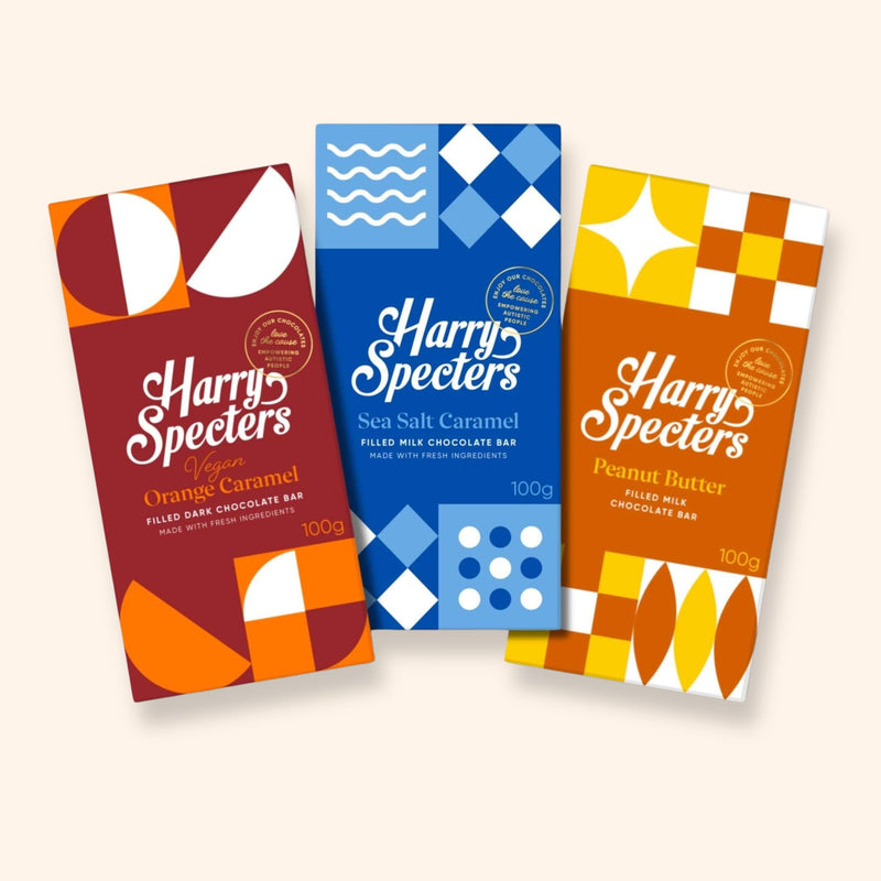 Three chocolate bars including dark vegan orange, sea salt caramel, and peanut butter flavours in colourful packaging