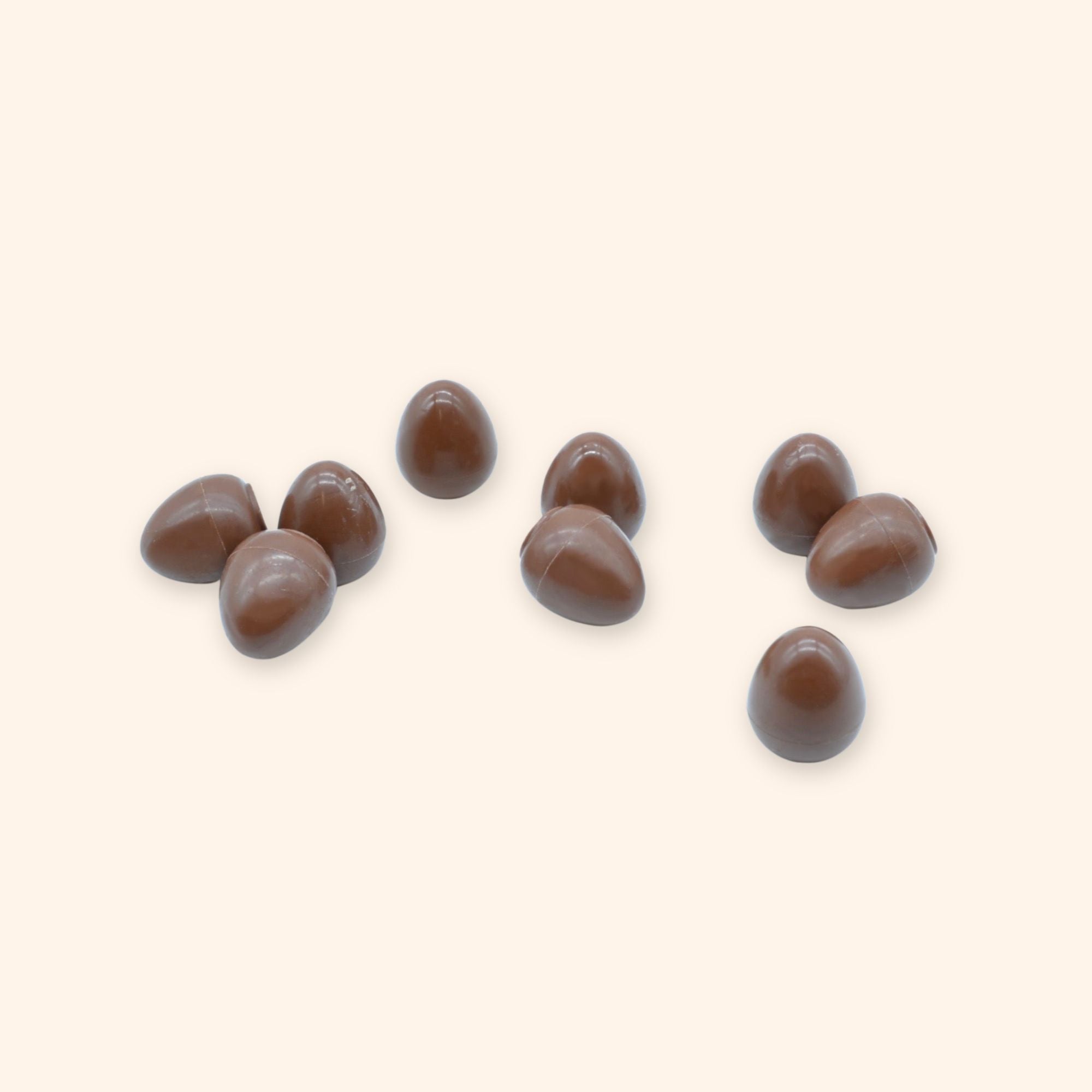 A pile of milk chocolate mini eggs filled with salted caramel