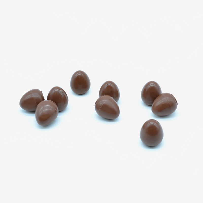 A pile of milk chocolate mini eggs filled with salted caramel