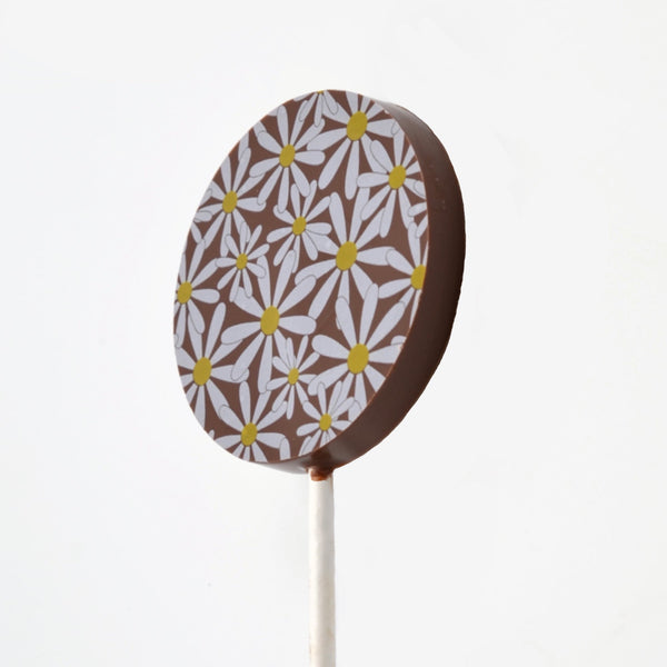 A milk chocolate lollipop with a daisy design