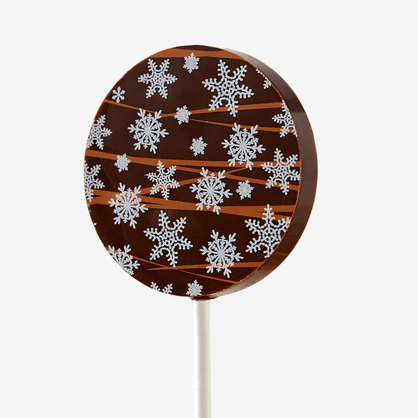 A milk chocolate lollipop with a Christmas design featuring snowflakes
