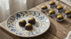 Mango calamansi chocolates on a decorative plate