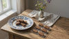 Honey and saffron chocolates on a wooden table with a vase of flowers