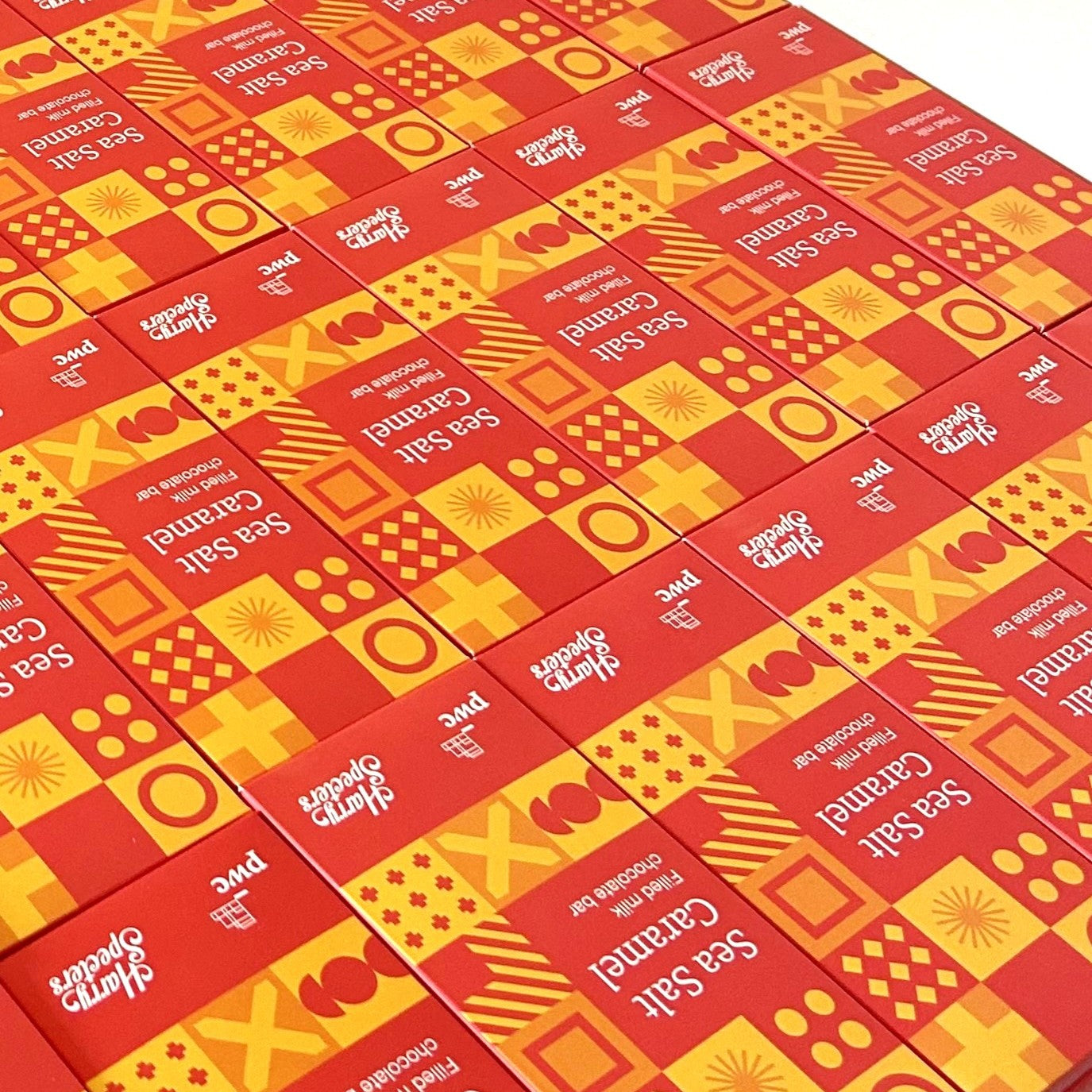 Multiple personalised chocolate bar boxes with colourful patterns and text on a white background