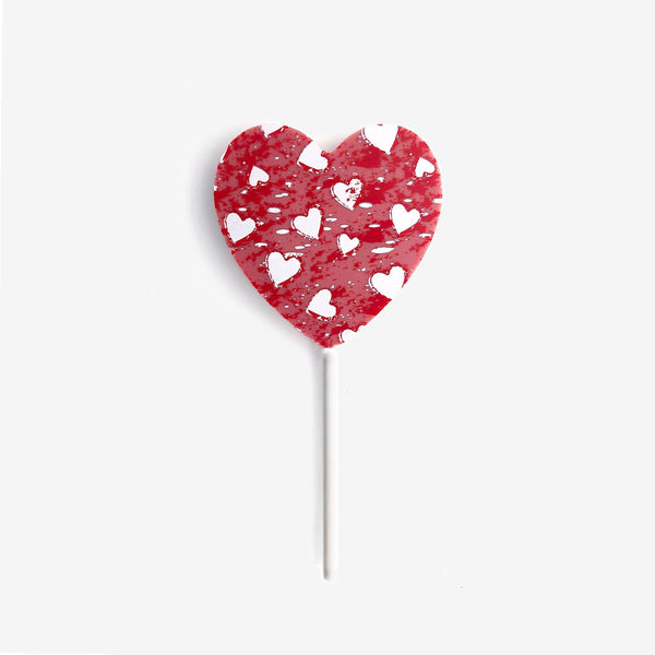 A heart shaped ruby chocolate lollipop featuring a heart design