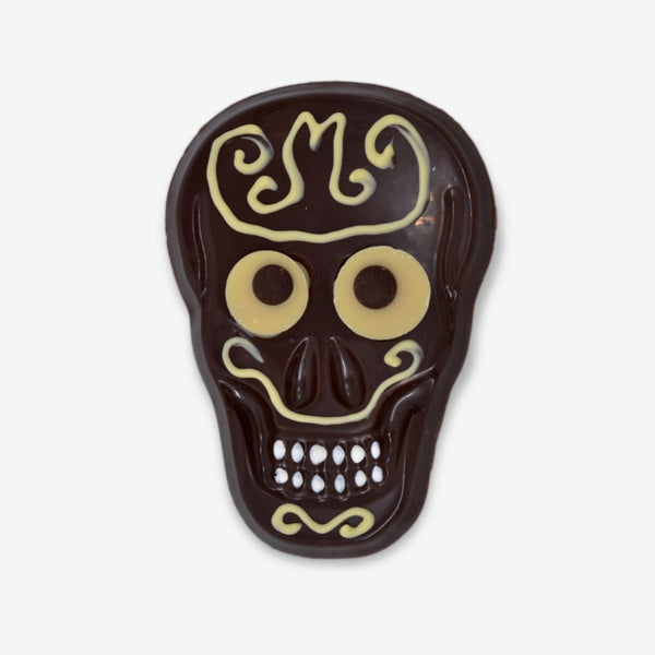 A dark chocolate skull decorated with white chocolate for Halloween