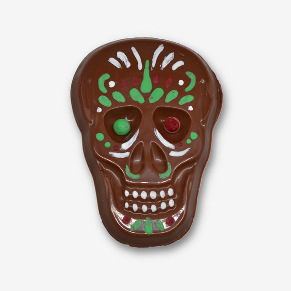 A milk chocolate skull decorated with colourful cocoa butter for Halloween