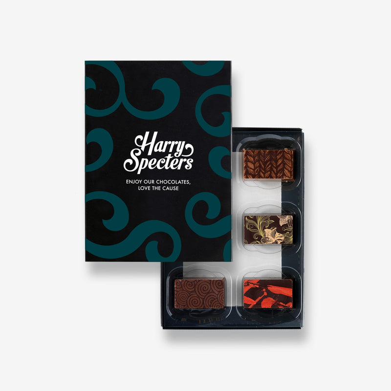 A box of 6 artisan chocolates by Harry Specters including Teachers gift themed designs partially covered by a box lid 