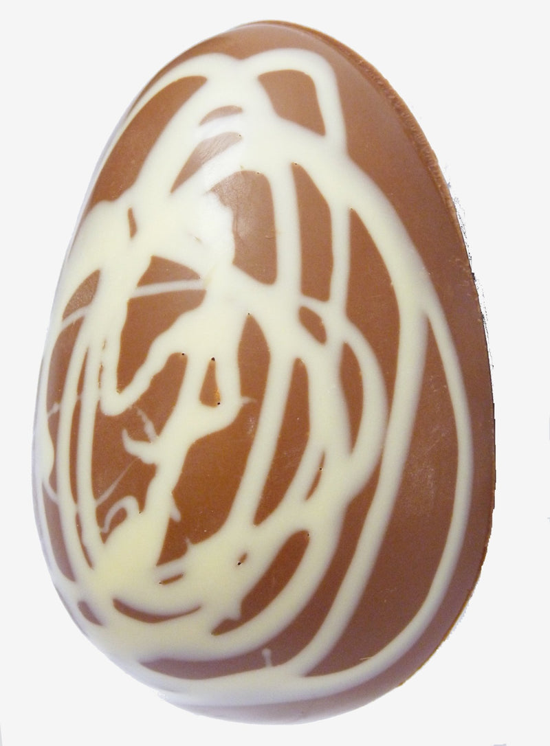 A caramel chocolate Easter egg with a white chocolate swirl