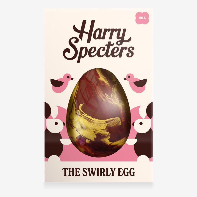 A milk chocolate Easter egg decorated with red and gold swirls in a colourful box with an Easter bunny design
