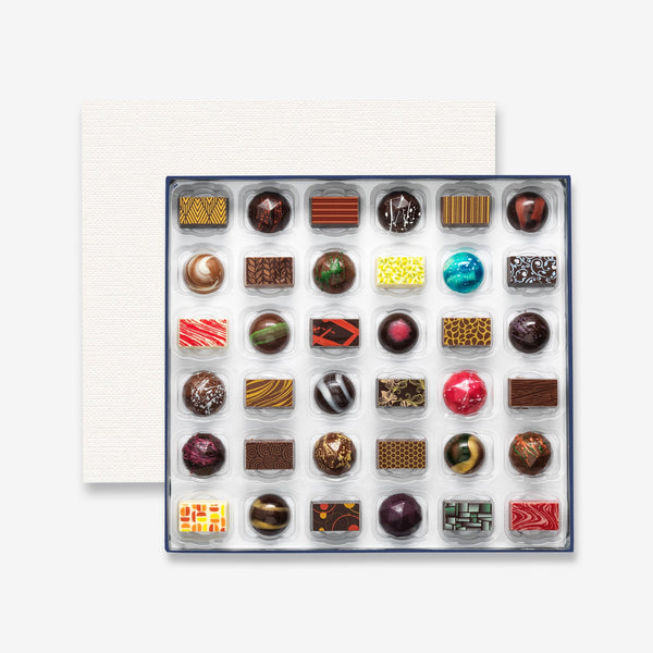 A box of 36 artisan chocolates colourfully decorated 