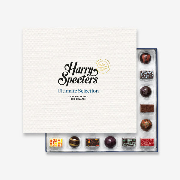 A box of 36 artisan chocolates by Harry Specters partially covered by a box lid 