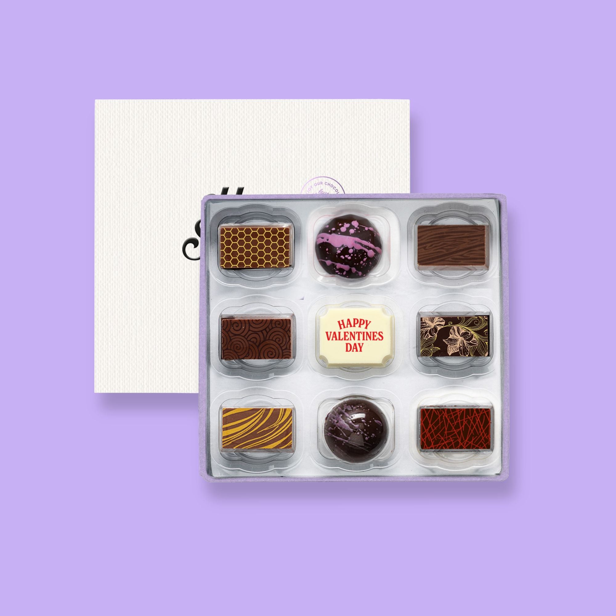 A box of 9 artisan chocolates colourfully decorated and featuring a chocolate with the message For My Valentine