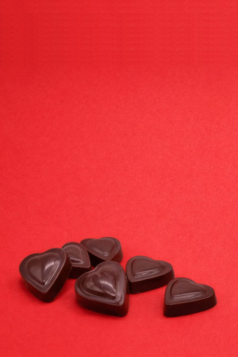 Dark chocolate valentine's day hearts on a red background