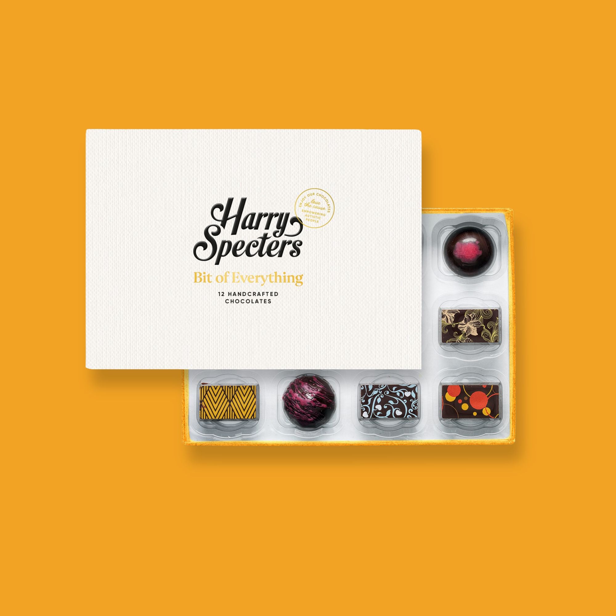 A box of 12 artisan vegan chocolates by Harry Specters partially covered by a box lid 
