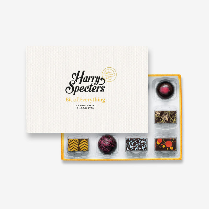 A box of 12 artisan vegan chocolates by Harry Specters partially covered by a box lid 
