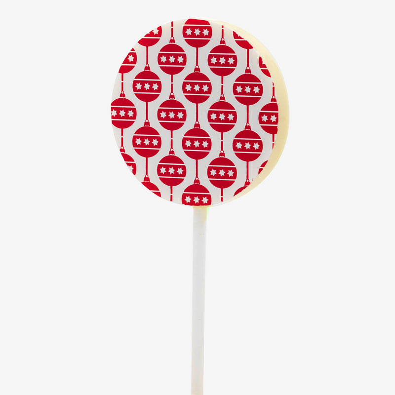 A white chocolate lollipop featuring a Christmas bauble design