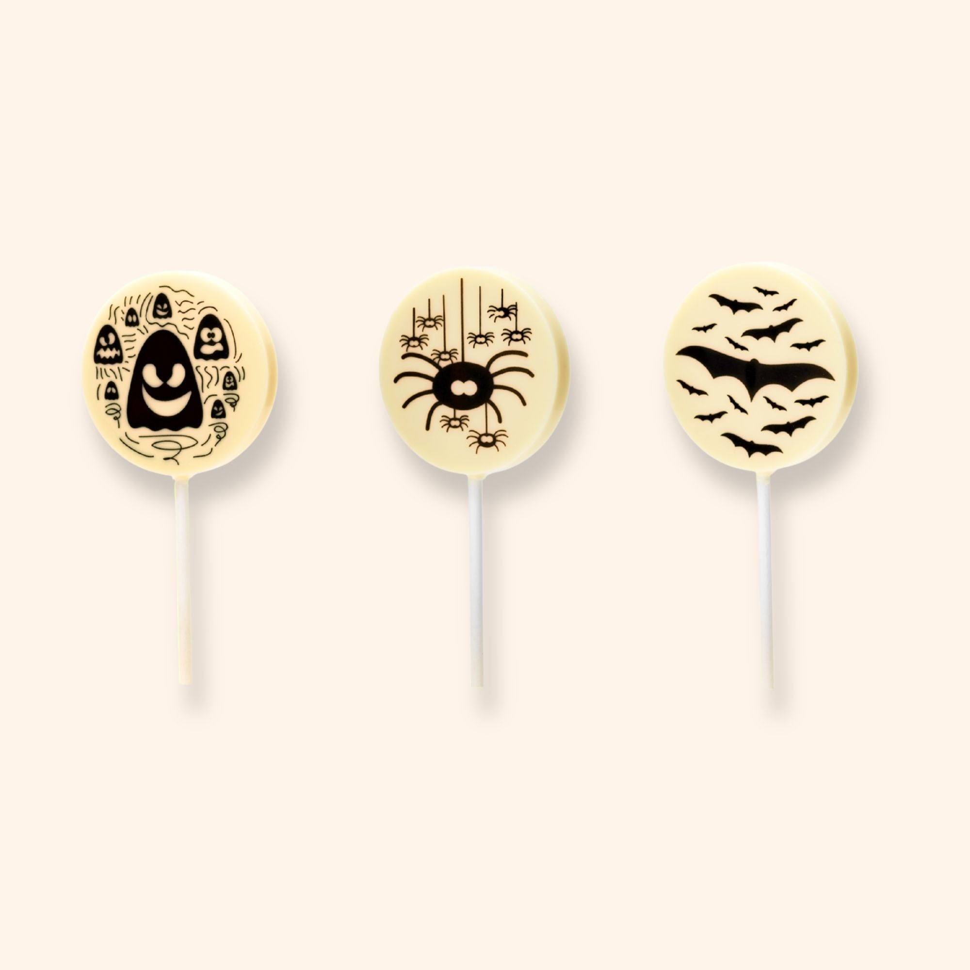 3white chocolate lollipops featuring Halloween designs including ghosts, spiders, bats, a skull, and the word boo