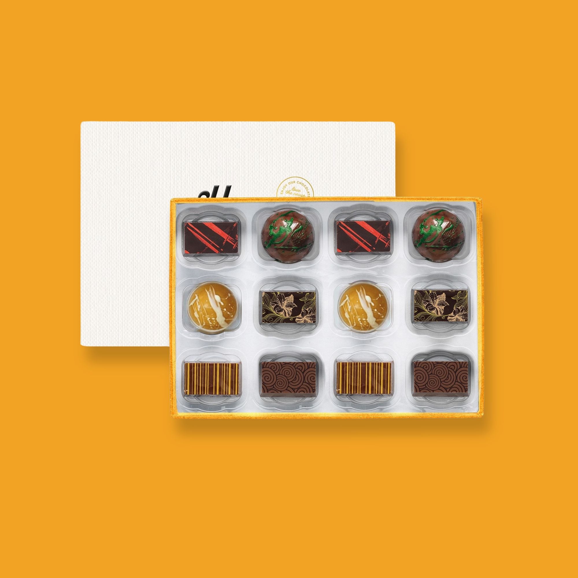 A box of luxury artisan chocolates decorated by hand.